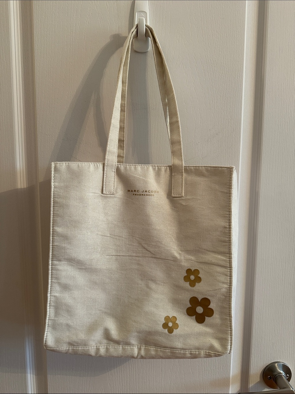 Marc Jacobs fragrance gold and cream tote bag